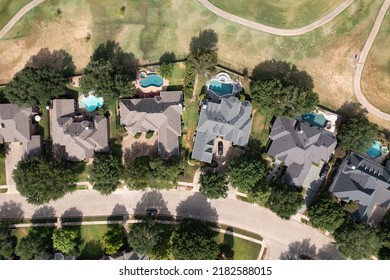 Aerial drone view of luxury homes in affluent suburban city neighborhood