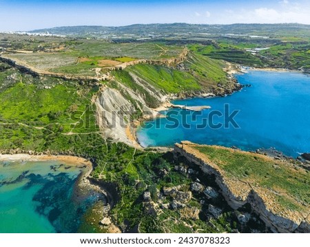 Aerial drone view of maltese bay and beach. Spring, green countryside. Ghain Tuffieha, Malta island