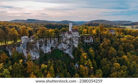 Aerial drone view medieval Lichtenstein castle on mountain, autumn Baden-Wurttemberg, Germany