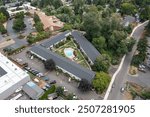 Aerial Drone view of a Multifamily residential apartment buildings complex with beautiful blue swimming pool in a nice neighborhood in Beaverton, Oregon