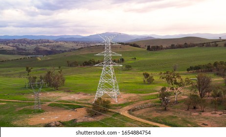 Aerial Drone View Of A Newly Constructed Electric Transmission Tower On Mountainous Green Fields At Strathnairn In Canberra, The Capital City Of Australia, In The Late Afternoon