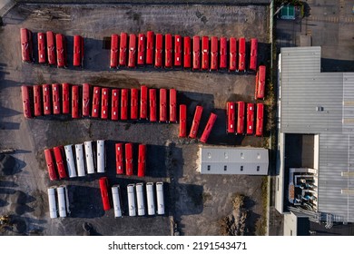  Aerial Drone View On Bus Parking And Repair Garage. Row With Red Color Coaches And Service Building. Top Down View.