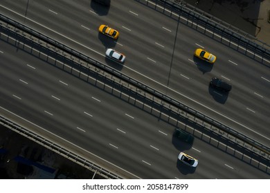 Aerial Drone View On Highway Bridge With Different Automobies. Road With Four Lanes Traffic Flow In Both Directions. Many Cars, Trucks On The Road. Urban Transportation System