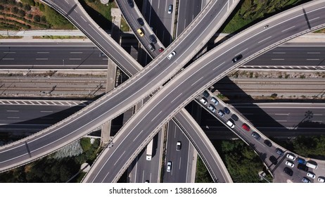 Aerial drone view of popular highway multilevel junction road, passing through National motorway in traffic jam - Shutterstock ID 1388166608