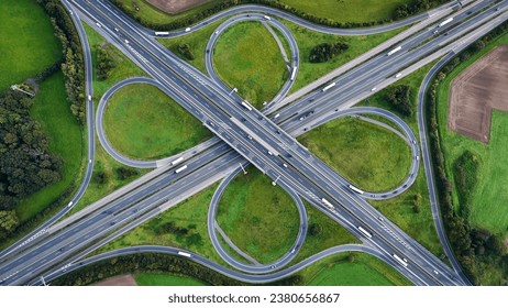 Aerial drone view road junction. Clover roundabout view from above. Car traffic on autobahn Germany. High quality photo