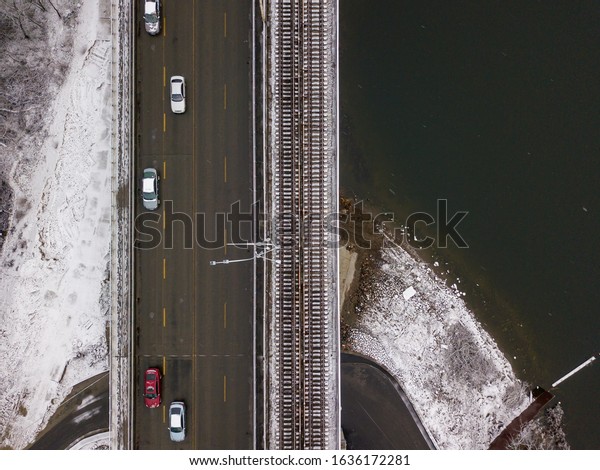 Aerial\
drone view. Road and railway bridge in the\
snow.