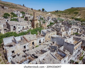 Aerial drone view of the ruins of Poggioreale on the Belice valley, in the province of Trapani. The town was destroyed by and earthquake in 1968. Abandoned empty eerie ghost town in Sicily. - Shutterstock ID 2094336097