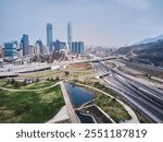 Aerial Drone View of Santiago de Chile Featuring Urban Green Spaces, Modern Highways, and the Iconic Costanera Center Tower in the Skyline