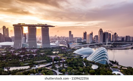 Aerial Drone View Of Singapore City Skyline At Sunset