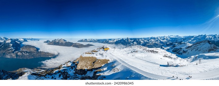 Aerial drone view of snow covered mountains and ski slopes, ski area Stoos,Switzerland