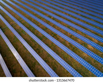 Aerial Drone View Of Solar Panels At A Solar Energy Generation Farm At Sunset In South Wales, UK