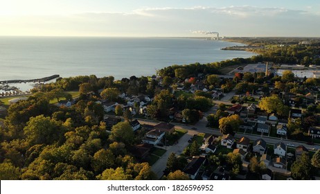Aerial drone view of suburban neighborhood on the shoreline of Lake Michigan. Establishing shot of American suburb, street. Residential houses in Milwaukee, Wisconsin