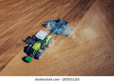 Aerial Drone View Of Tractor Plowing On The Field. Agro Machinery From Above.