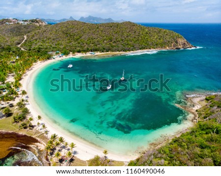 Aerial drone view of tropical island of Mayreau and turquoise Caribbean sea in St Vincent and Grenadines