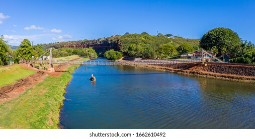 Aerial drone view of the wooden swinging bridge of Hanapepe over the river on Kauai