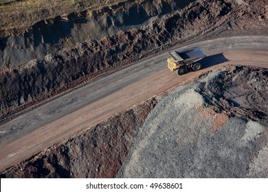 Aerial of a dump truck in a quarry.