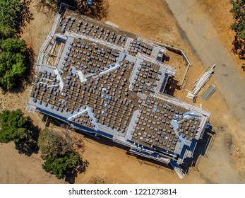 An Aerial Eagle Eye View Of New House Rooftop With Tiles Ready For Installation