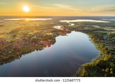 Aerial early summer morning view of small rural village between lakes called Inturke in Moletai region, Lithuania - Shutterstock ID 1125687773