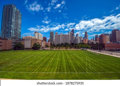 Aerial Elevated View Up Above A Soccer Football Field, Chicago, Looking East Towards Chicago's Gold Coast Neighborhood Under A Blue Sky