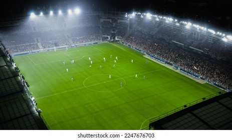 Aerial Establishing Shot of a Whole Stadium with Soccer Championship Match. Teams Play, Crowd of Fans Cheer. Football Tournament, Cup Broadcast. Sports Channel Television, Screen Content.