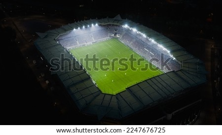 Aerial Establishing Shot of a Whole Stadium with Soccer Championship Match. Teams Play, Crowd of Fans Cheer. Football Tournament, Cup Broadcast. Sports Channel Television, Screen Content Concept.