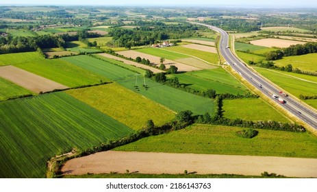 Aerial european countryside landscape at sunset. Drone point view of agricultural fields, roads, copses. Rural area. - Shutterstock ID 2186143763