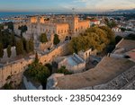 Aerial, evening view of the   illuminated Palace of the Grand Master of the Knights of Rhodes in golden hour.  Ancient architecture of Greece. Travel destinations of Rhodes island. 