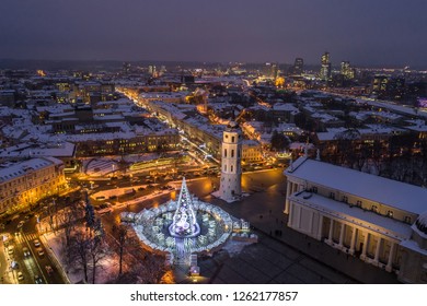 Aerial evening view of snow covered Vilnius Cathedral square decorated for Christmas celebrations in Lithuania