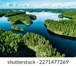 Aerial Finland landscape. Aerial view of blue lakes with rock islands and green woods in summer
