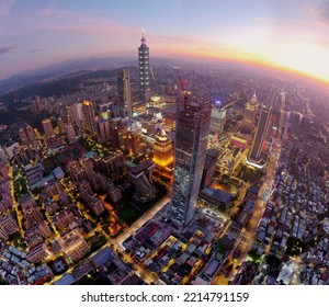 Aerial fish-eye view of Downtown Taipei, the vibrant capital city of Taiwan, with 101 Tower standing out among modern skyscrapers in Xinyi District and city lights dazzling under golden sunset sky - Powered by Shutterstock