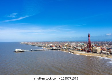 Aerial footage, drone view , of the famous Blackpool Tower and beach from the sky on a beautiful Summers day on one of Great Britains most popular holiday destinations, tourist attractions by the sea