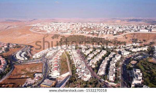  Aerial footage of\
Israel and Palestine town divided by fence \
Aerial view of Anata\
town close to Israeli pisgat zeev neighbourhood in east\
Jerusalem\
