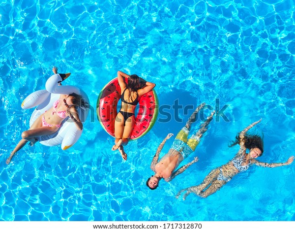 aerial-friends-having-party-swimming-600w-1717312870.jpg