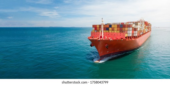 Aerial in front of cargo ship carrying container and running with tug boat for export cargo .