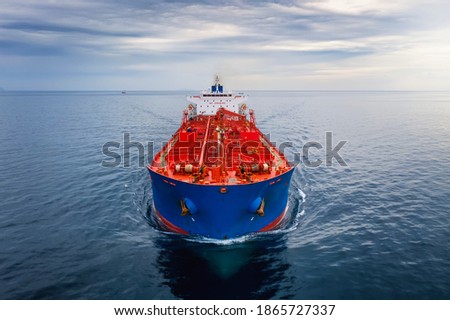 Aerial front view of a cargo tanker traveling over calm sea