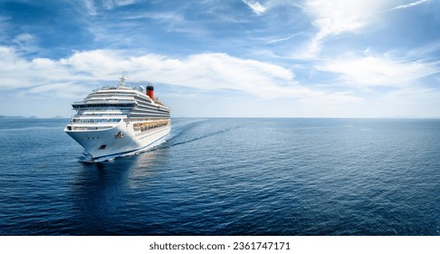 Aerial front view of a generic cruise ship traveling with speed over blue ocean with copy space