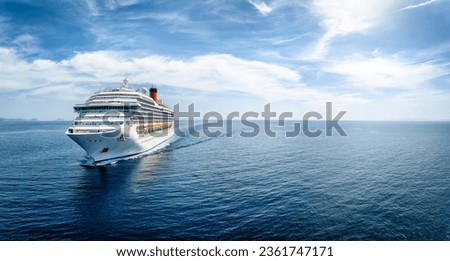 Aerial front view of a generic cruise ship traveling with speed over blue ocean with copy space