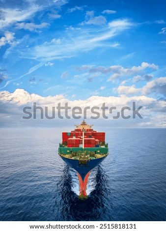 Aerial front view of a large container cargo ship sailing over the ocean with speed with the sky as copy space