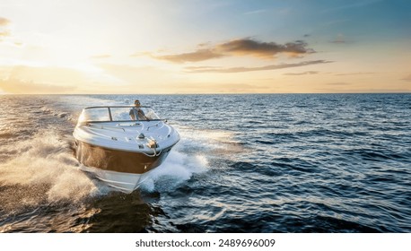 Aerial front view of a motor boat cruising with speed over the ocean during sunset time with copy space