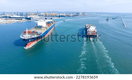 Aerial in front view of Two 2 Large Cargo Ship carrying container and running in Opposite direction for export import Cargo at sea sunset ocean concept technology transportation logistics