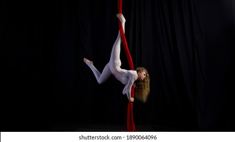 aerial girl professional circus performer performs acrobatic elements twist, flexibility, grace - Shutterstock ID 1890064096