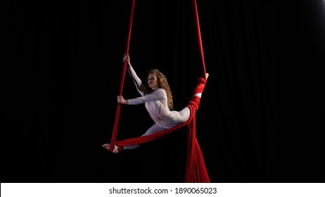 aerial girl professional circus performer performs acrobatic elements twist, flexibility, grace - Shutterstock ID 1890065023