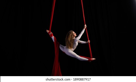 aerial girl professional circus performer performs acrobatic elements twist, flexibility, grace - Shutterstock ID 1890887917