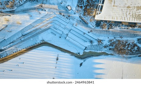 Aerial Golden Hour Snowscape with Geometric Staircases and Frozen River - Powered by Shutterstock