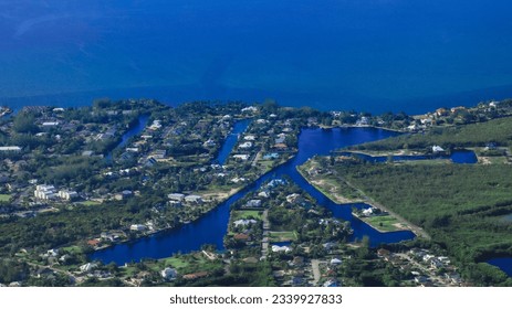 Aerial of Grand Cayman, Cayman Islands British overseas territory in the Caribbean with lush greenery and buildings  - Shutterstock ID 2339927833