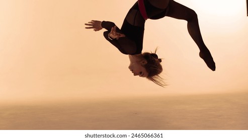 Aerial gymnastics. Gymnast performs tricks on canvases. Close-up of aerial gymnast upside down. - Powered by Shutterstock