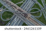 Aerial highway junction bustling with traffic, urban connectivity showcased Drone shot seamless flow, infrastructure strength. Efficient transportation, arterial roadways converge, pulse of city life.