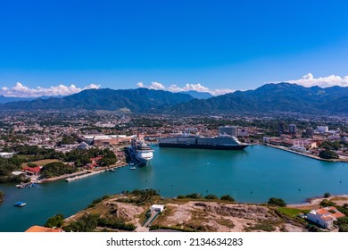 Aerial hyperlapse revealing a huge cruise ship docked at the API Marine Terminal with a beautiful sunset in the background - Powered by Shutterstock