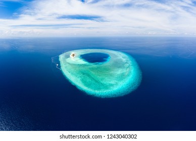 Aerial idyllic atoll, scenic travel destination Maldives Polinesia. Blue lagoon and turquoise coral reef. Shot in Wakatobi National Park, Indonesia