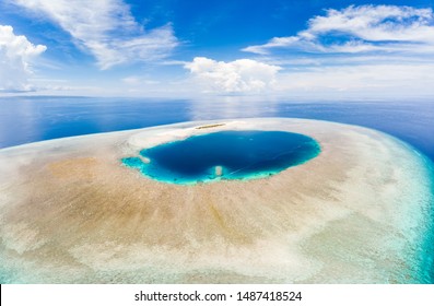 Aerial idyllic atoll, scenic travel destination Maldives Polinesia. Blue lagoon and turquoise coral reef. Shot in Wakatobi National Park, Indonesia